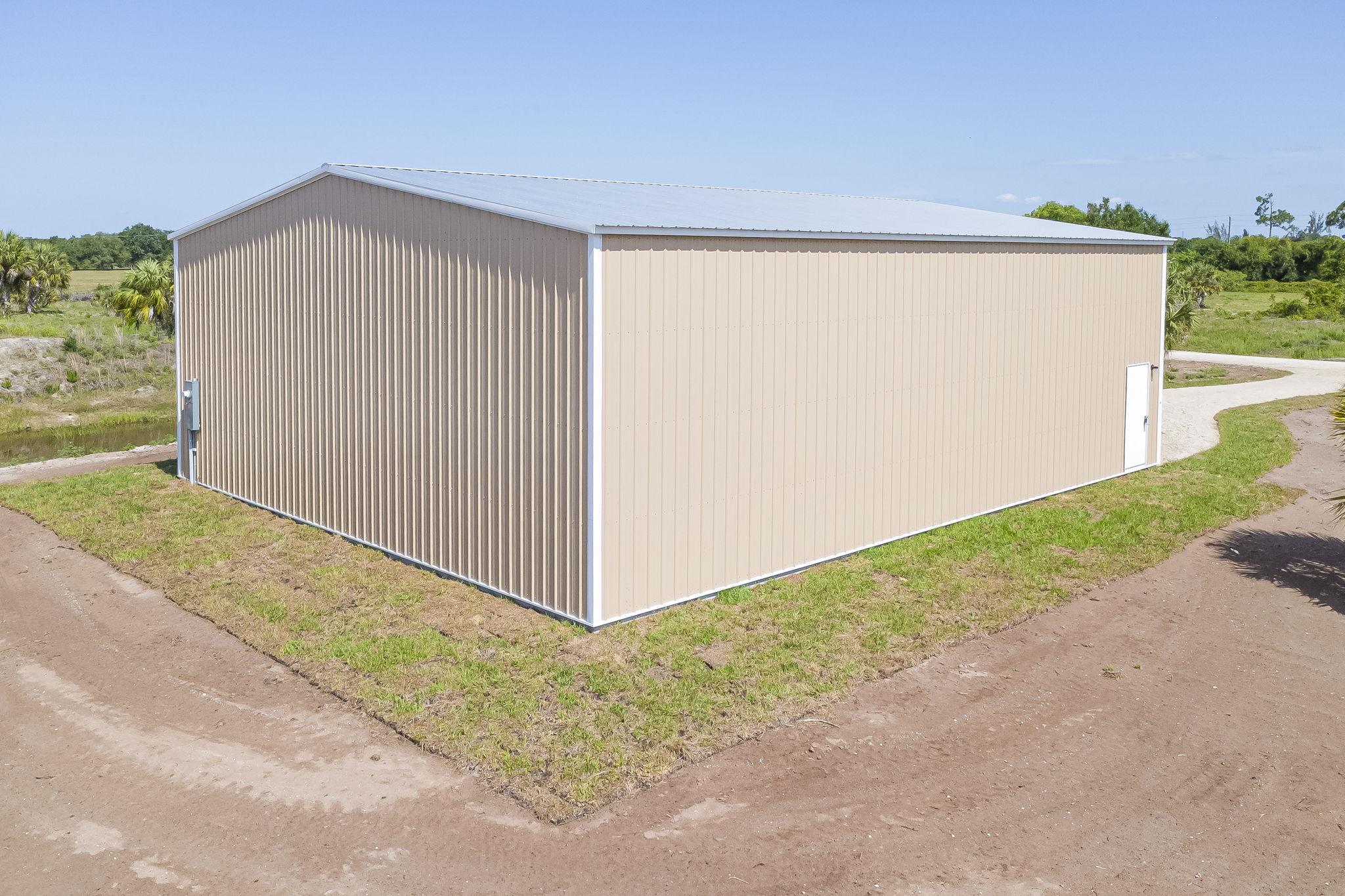 Elevated rear elevation view showcasing the durable steel paneling and reinforced wind-rated construction of the warehouse.