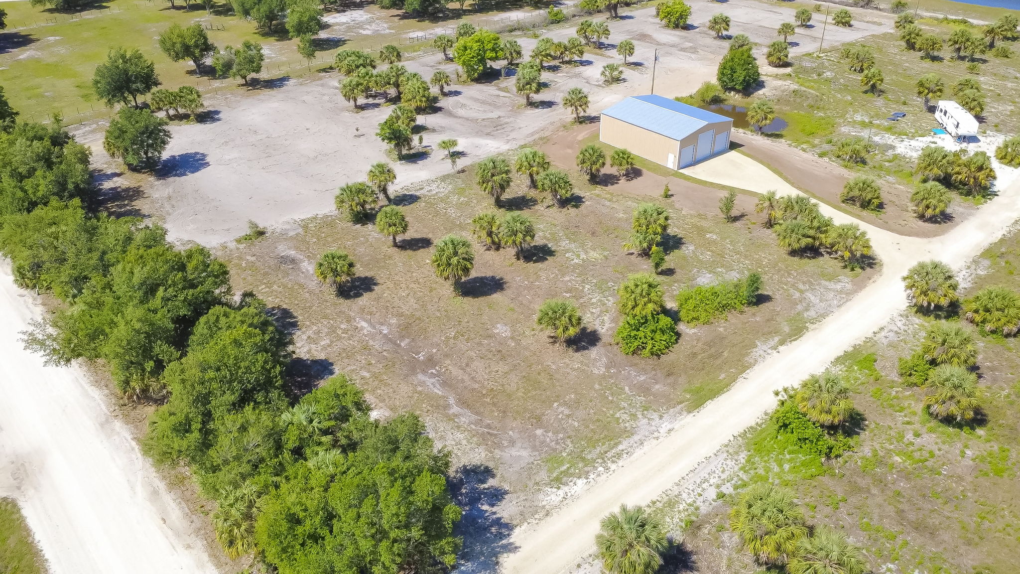 High-altitude aerial view revealing the property's deep lot lines and its integration into the surrounding Punta Gorda landscape.