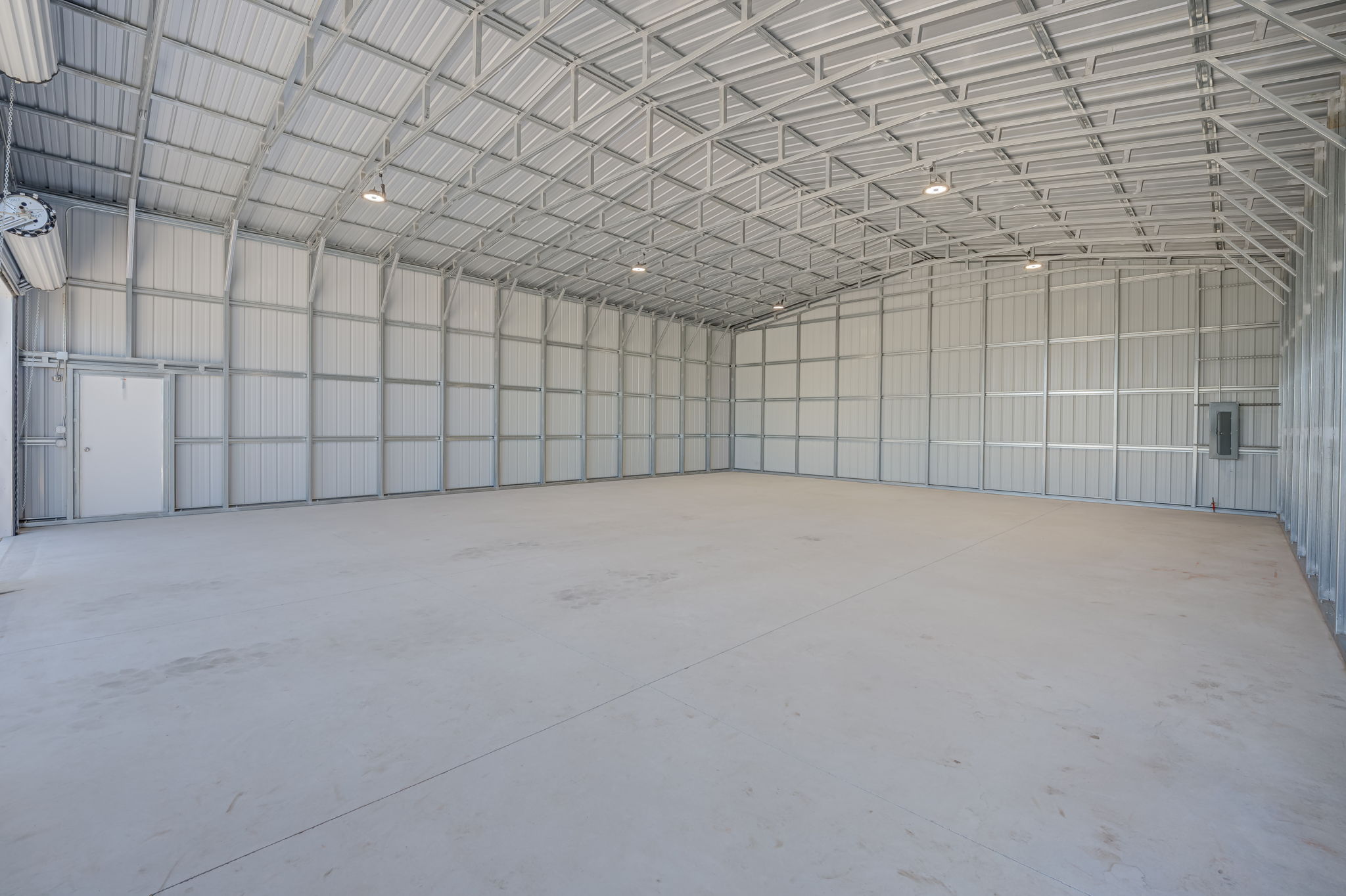 Corner interior perspective demonstrating the immense square footage and uninterrupted clear-span floor plan.