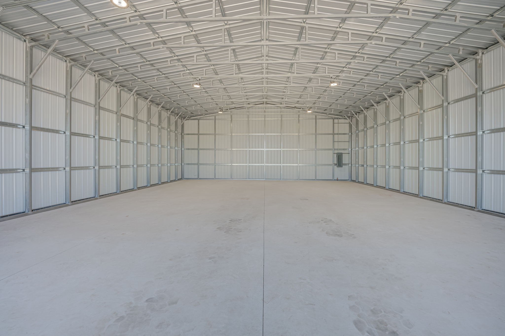 Interior view of the closed overhead bay doors emphasizing their heavy-duty track systems and wind-load reinforcement.