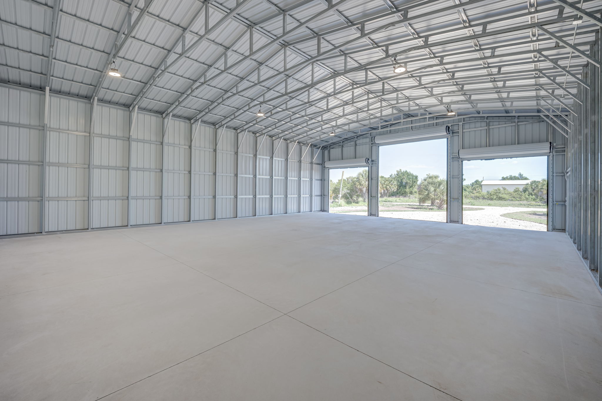 Secondary interior angle focusing on the structural integrity of the steel walls and the commercial overhead door mechanisms.
