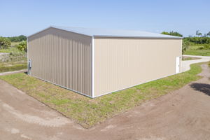 Elevated rear elevation view showcasing the durable steel paneling and reinforced wind-rated construction of the warehouse.