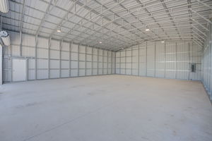 Corner interior perspective demonstrating the immense square footage and uninterrupted clear-span floor plan.