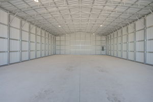 Interior view of the closed overhead bay doors emphasizing their heavy-duty track systems and wind-load reinforcement.