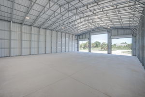 Secondary interior angle focusing on the structural integrity of the steel walls and the commercial overhead door mechanisms.