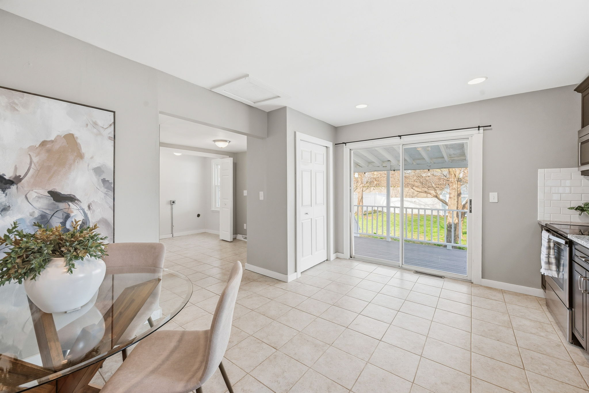 An entertainer's dream as the kitchen overlooks the covered deck and private backyard.