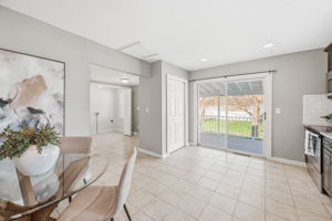 An entertainer's dream as the kitchen overlooks the covered deck and private backyard.