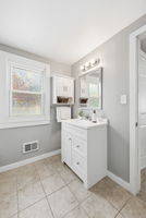 The bathroom is spacious with a linen closet and room if you want a larger vanity.