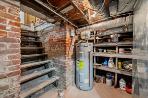 Heading to the lower level, you see the age of the home in the original cellar