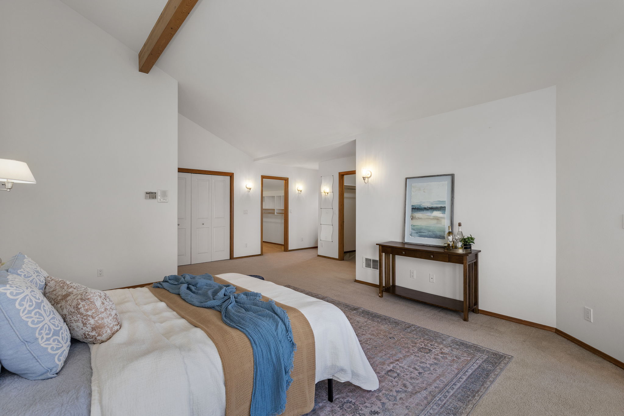 Another shot of the upper level primary looking on to closets and entrance to 5 piece primary bath.