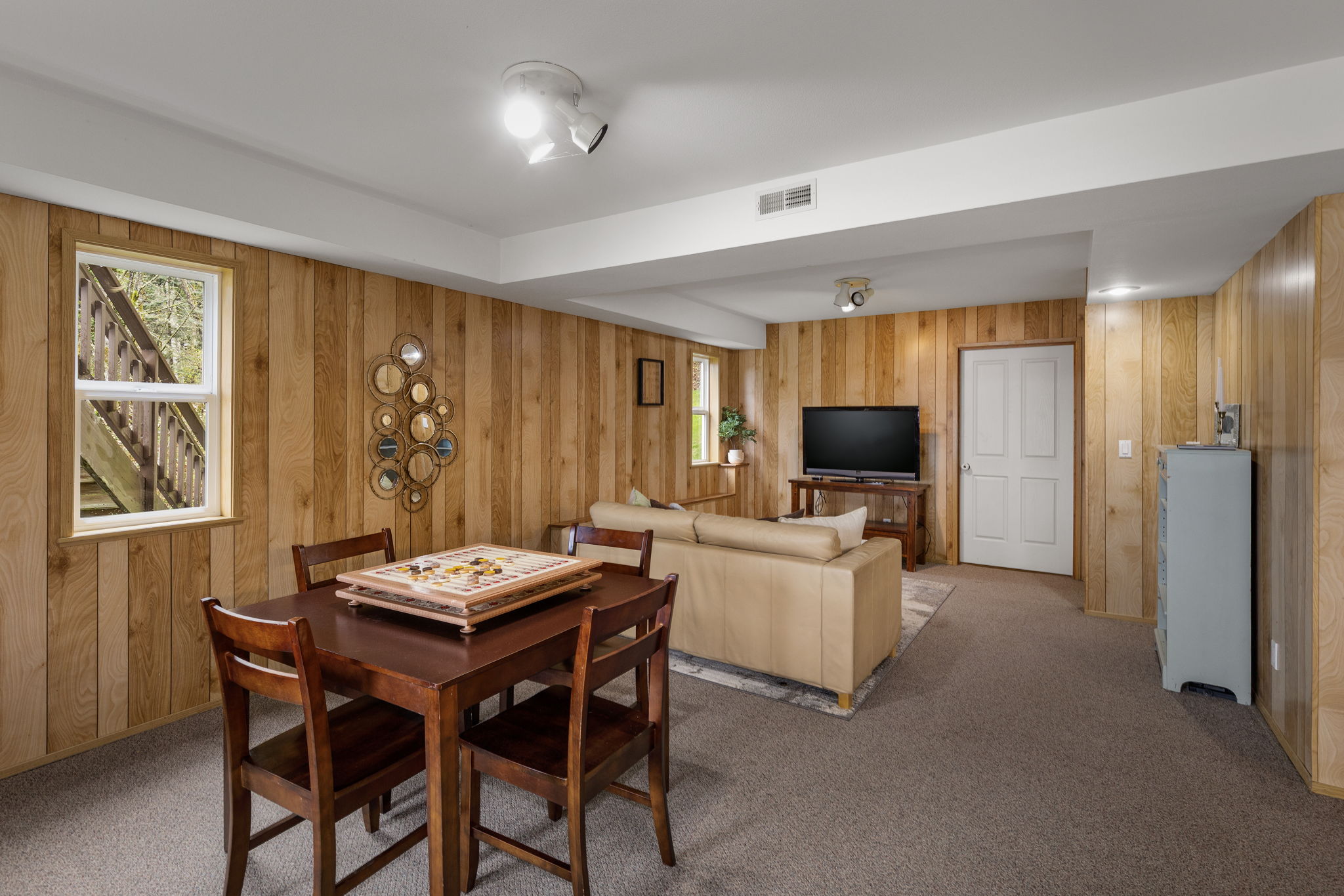 More of the lower level...HUGE storage room behind that door! This area plumbed for kitchenette!
