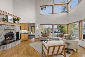 Family room with soaring ceilings, wet bar and fireplace.