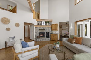 Family room with dedicated office out of shot to left and kitchen/eating nook ahead to right.