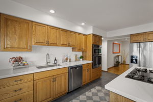 Through kitchen to dining where coral mirror is hanging.