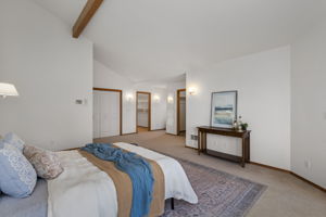 Another shot of the upper level primary looking on to closets and entrance to 5 piece primary bath.