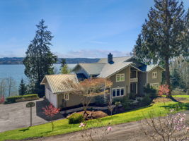 Welcome home to your waterfront paradise on nearly 5 acres...