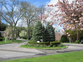 Flagpole circle in springtime, #61 2nd Floor End Unit at right