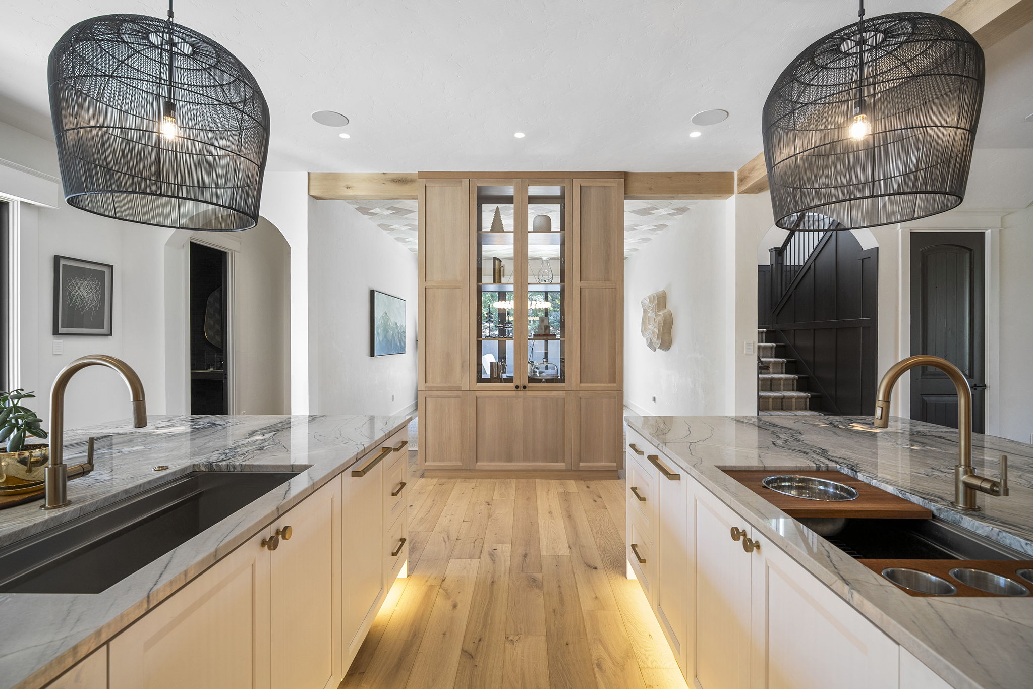 Each island has a Miele dishwasher, storage, and trash/recycling bins