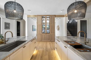 Each island has a Miele dishwasher, storage, and trash/recycling bins