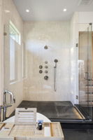 Glass enclosed spa shower with multiple heads