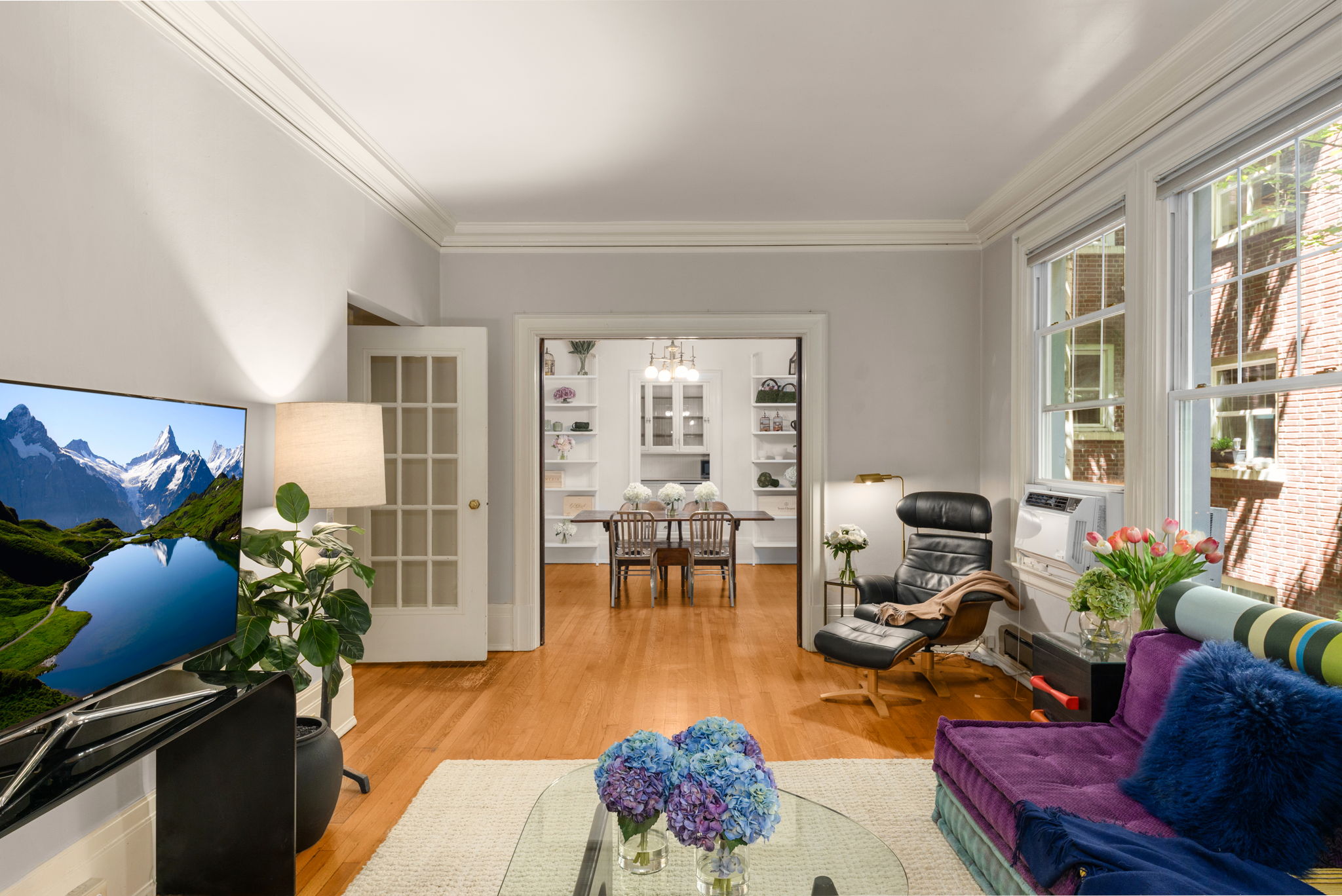Living room with large windows. A/C unit is included.