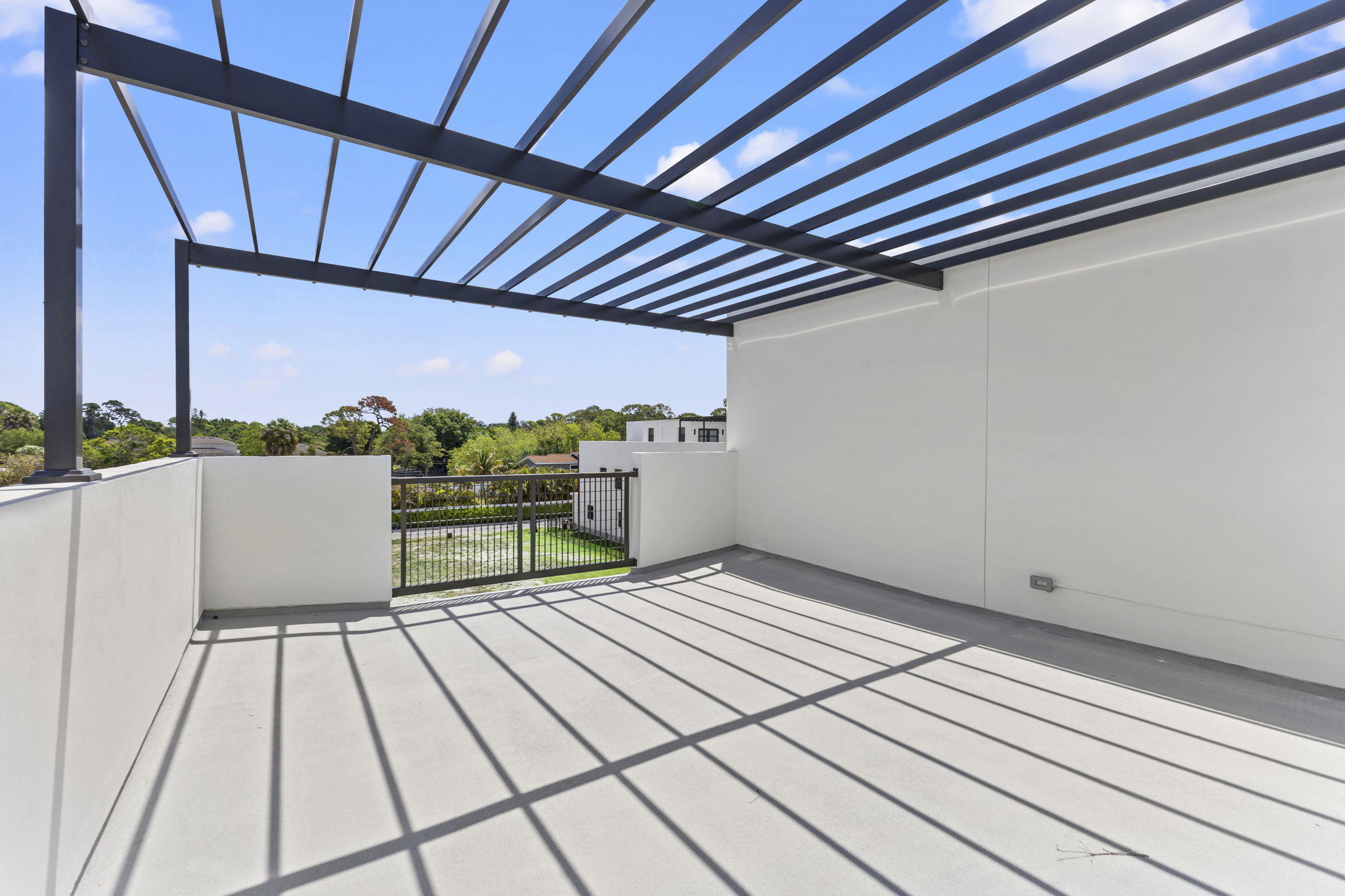 Pergola-covered rooftop terrace at dusk