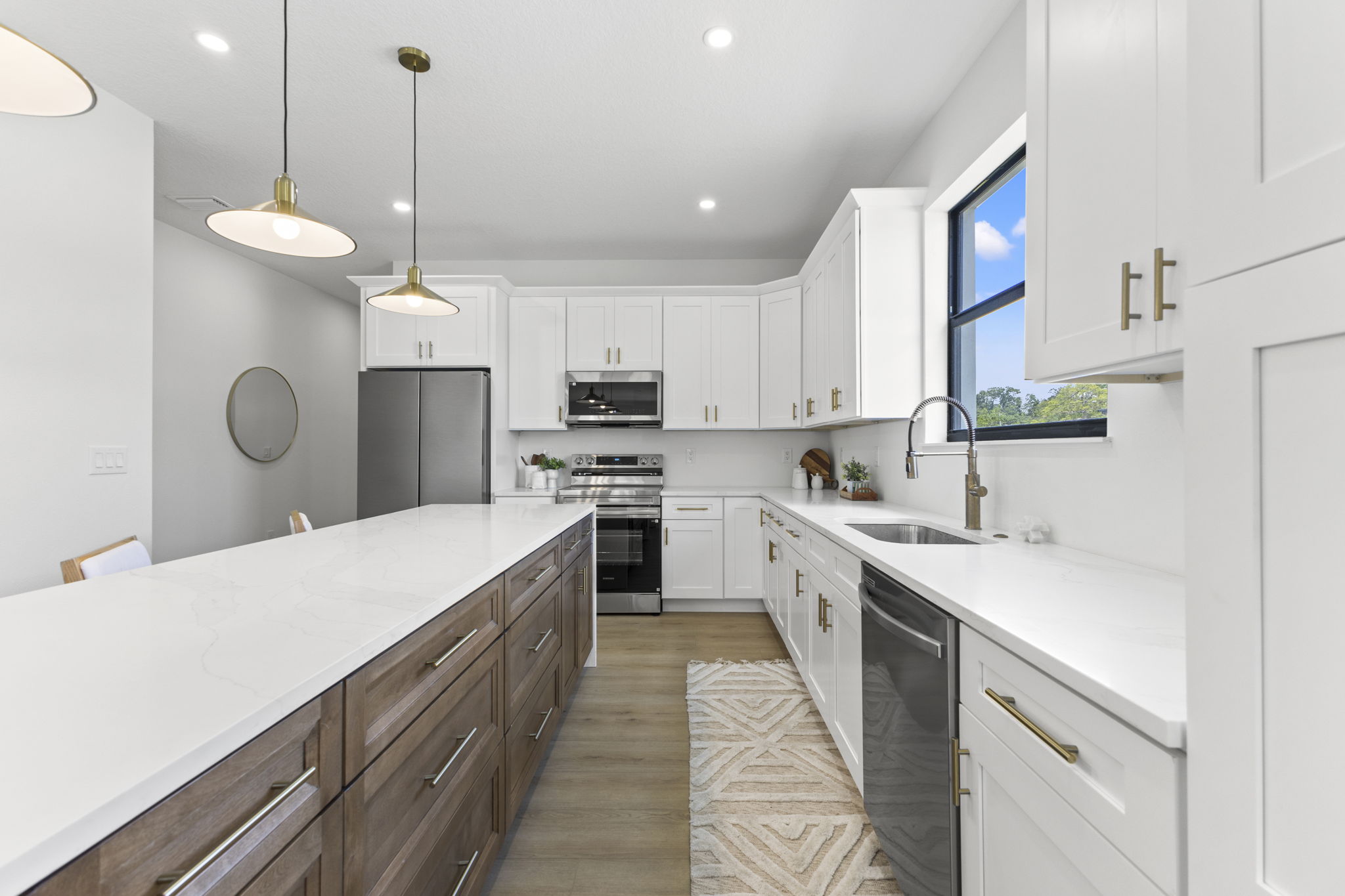 Kitchen with gold pendant lighting at Latitudes in the Park, Pinellas Park FL