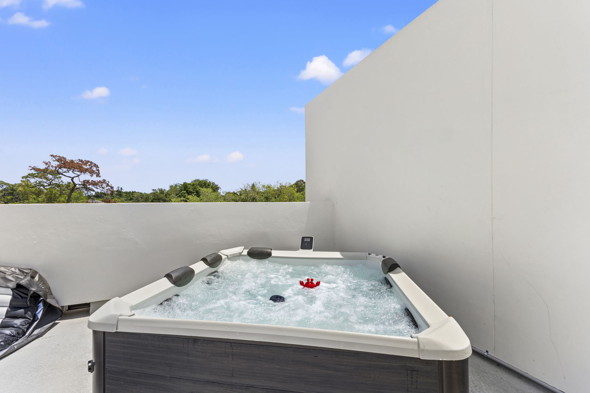 Spa tub set into the deck beside lounge seating on a rooftop terrace at Latitudes in the Park, Pinellas Park FL