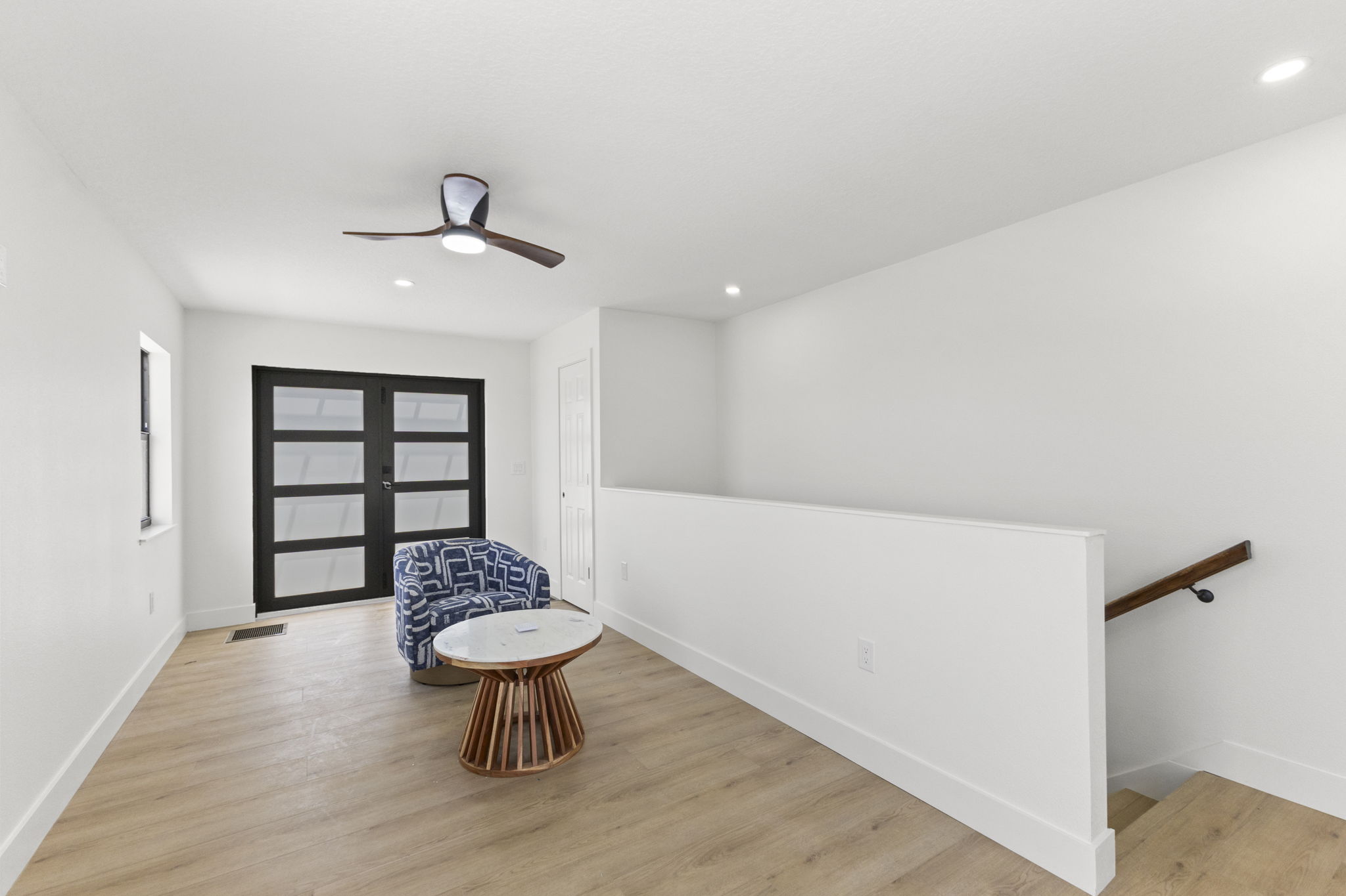 Third-floor loft and stair landing opening toward the terrace