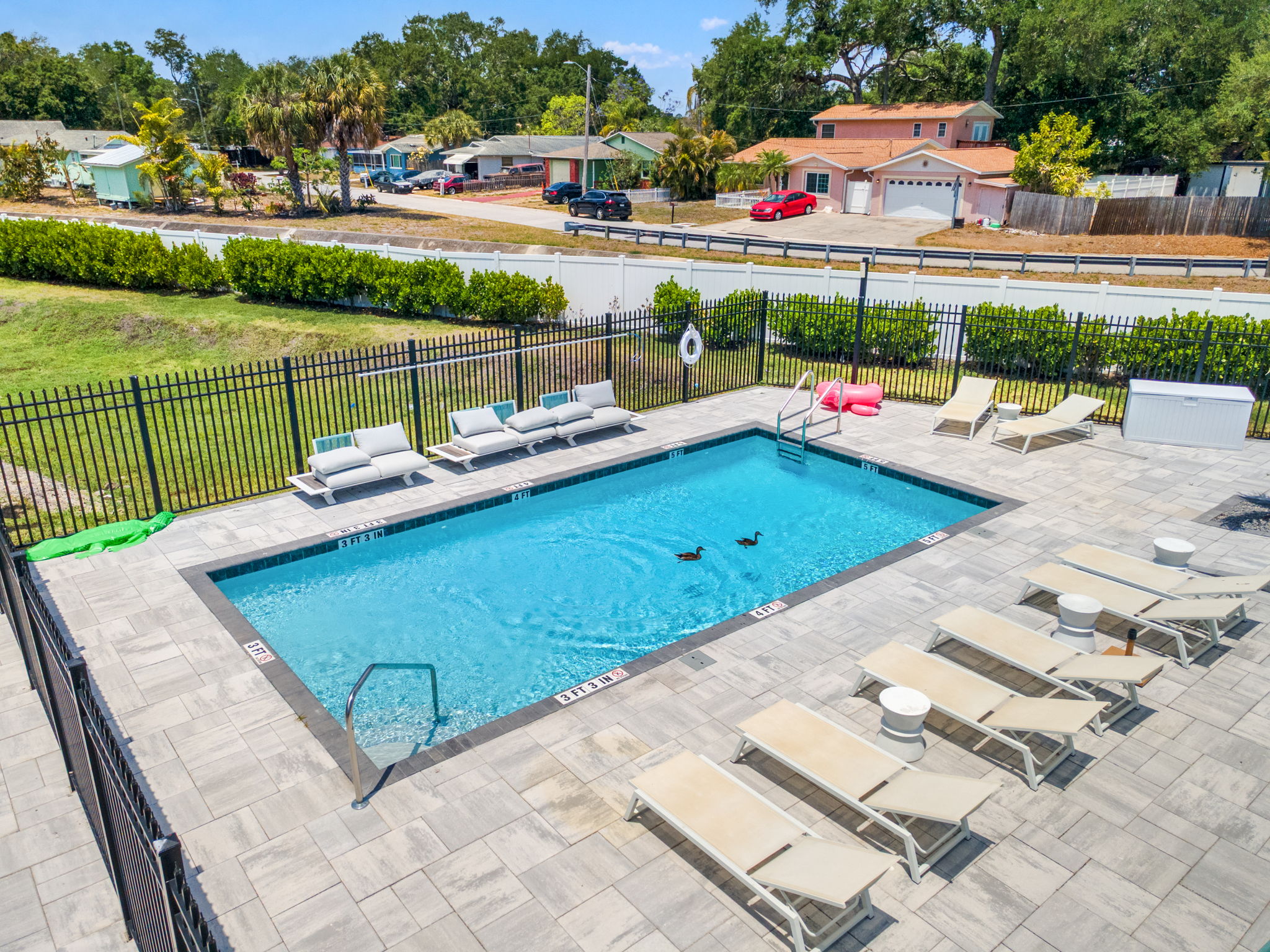Pool deck and sun loungers beside the on site common grounds at Latitudes in the Park, Pinellas Park FL