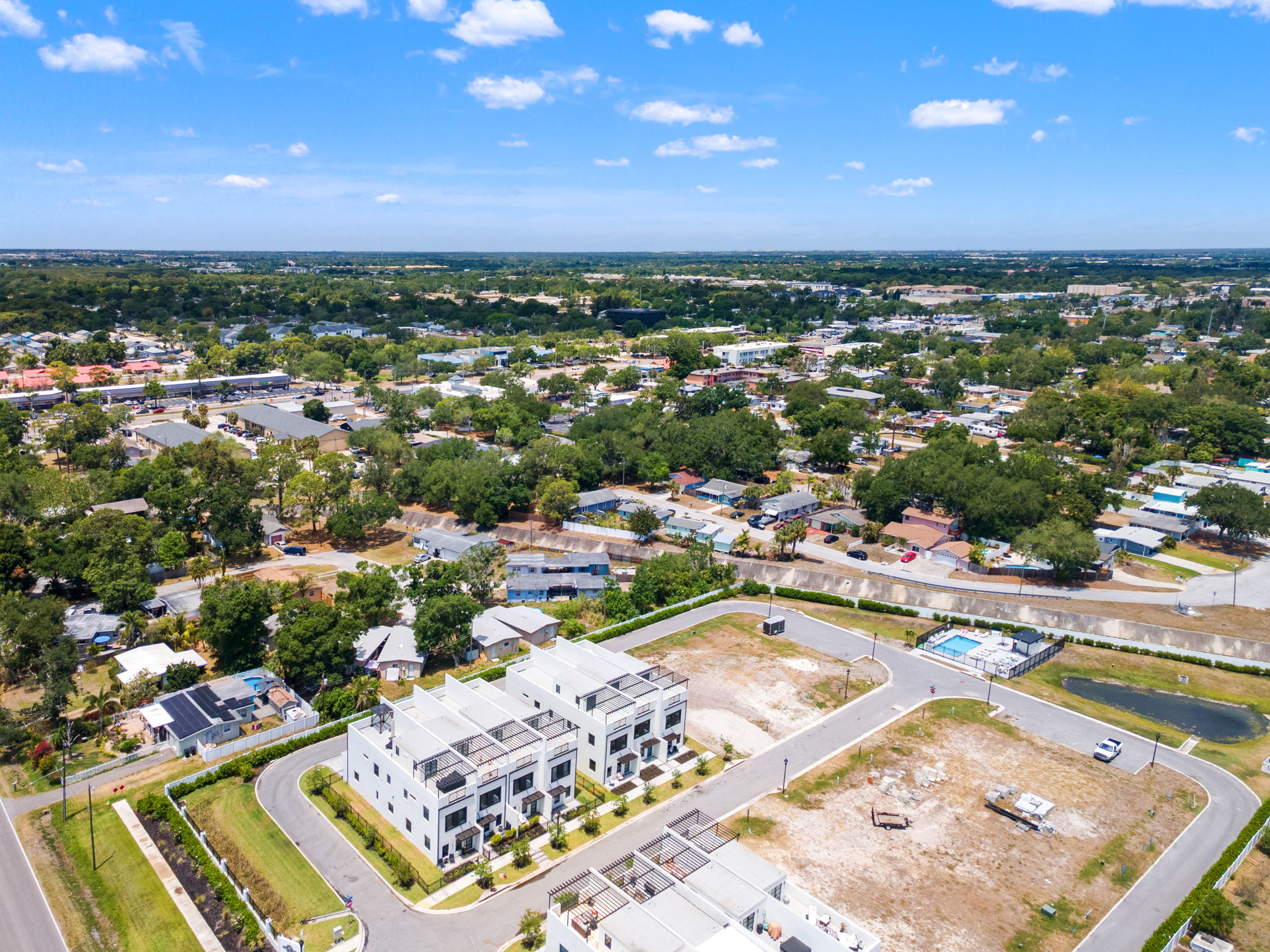 Aerial view of the 25 gated townhome residences and pool deck at Latitudes in the Park, Pinellas Park FL