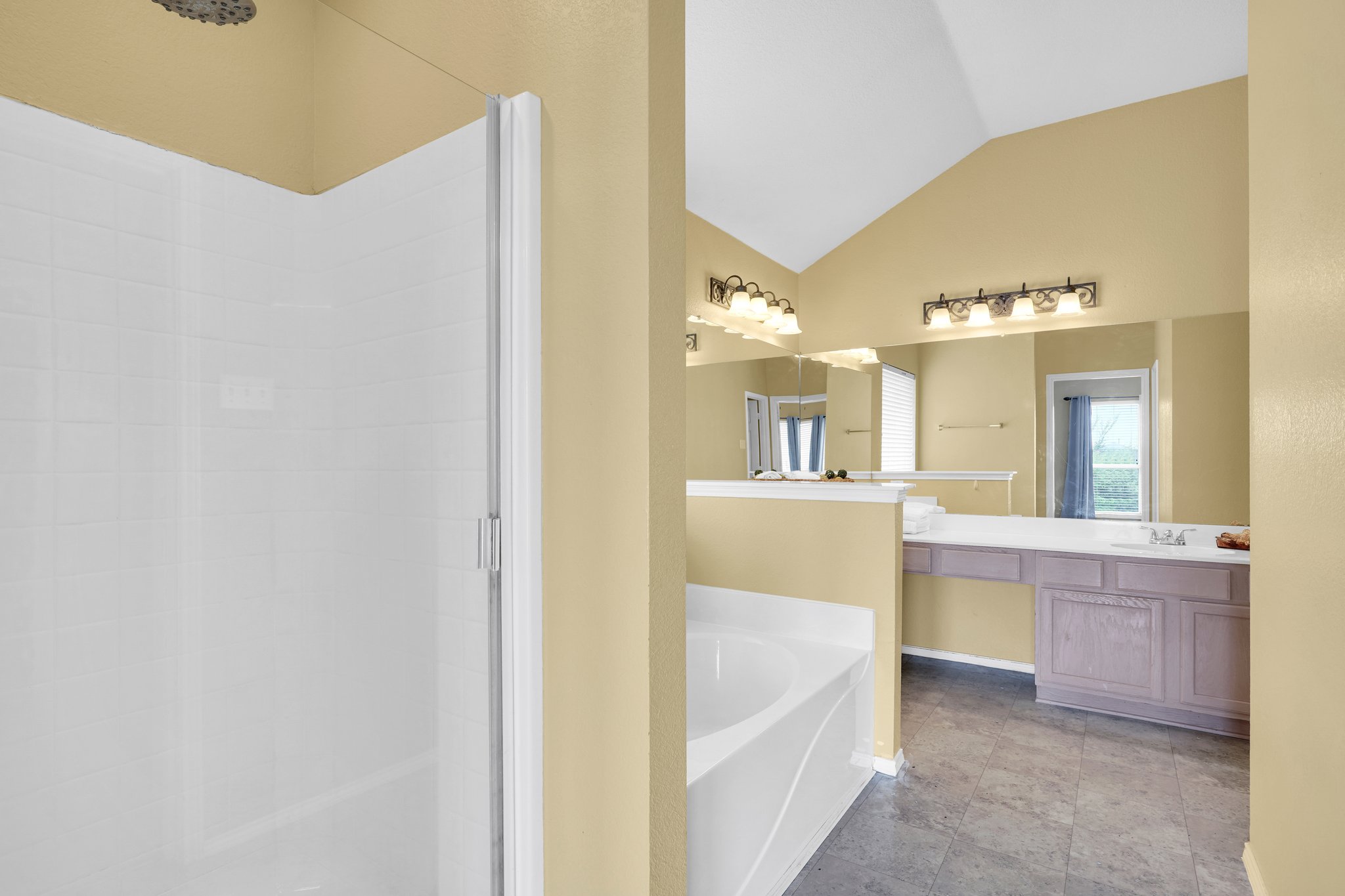 Primary bath features a garden tub & separate shower with waterfall panel