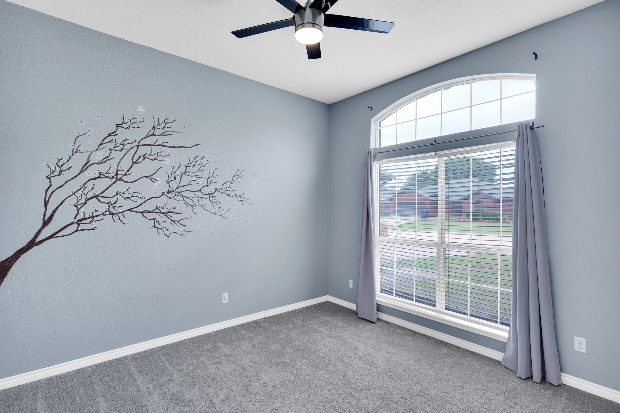 Nicely-sized secondary bedroom with fresh carpet, natural lighting and ceiling fan