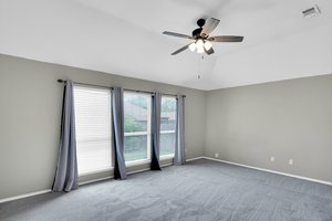 Your oversized primary suite features new carpet, ceiling fan and plenty of natural sunlight
