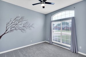 Nicely-sized secondary bedroom with fresh carpet, natural lighting and ceiling fan