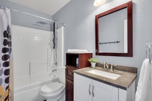 Full bath has all the necessities including sleek bath/shower combo with plenty of storage