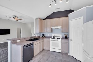 Kitchen is open to the spacious family room and offers extra dining space with a breakfast bar