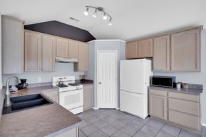 Kitchen boasts gas cooking, large pantry and a refrigerator which conveys with home