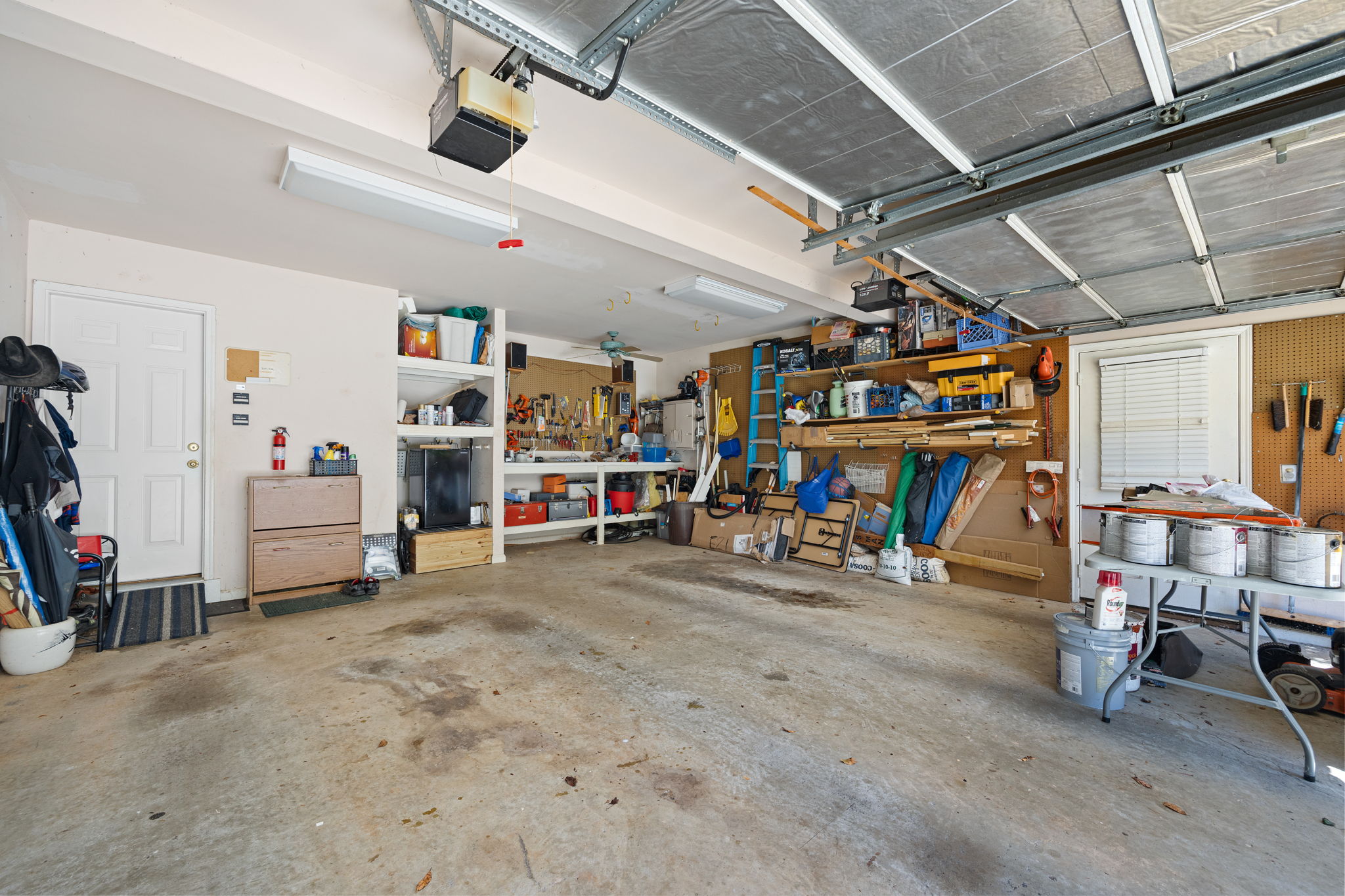Oversized garage with workbench and fan