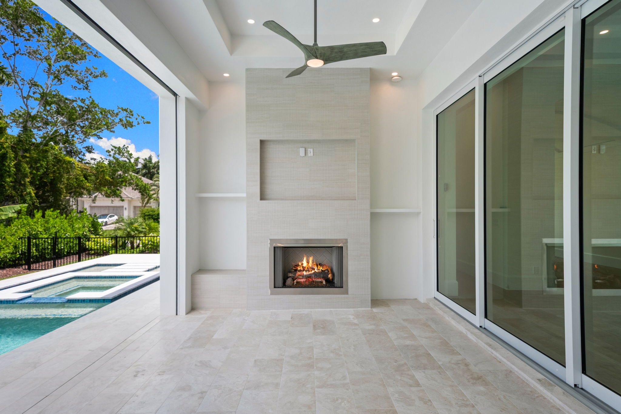 Outdoor area has automatic roll down screens and hurricane shutters