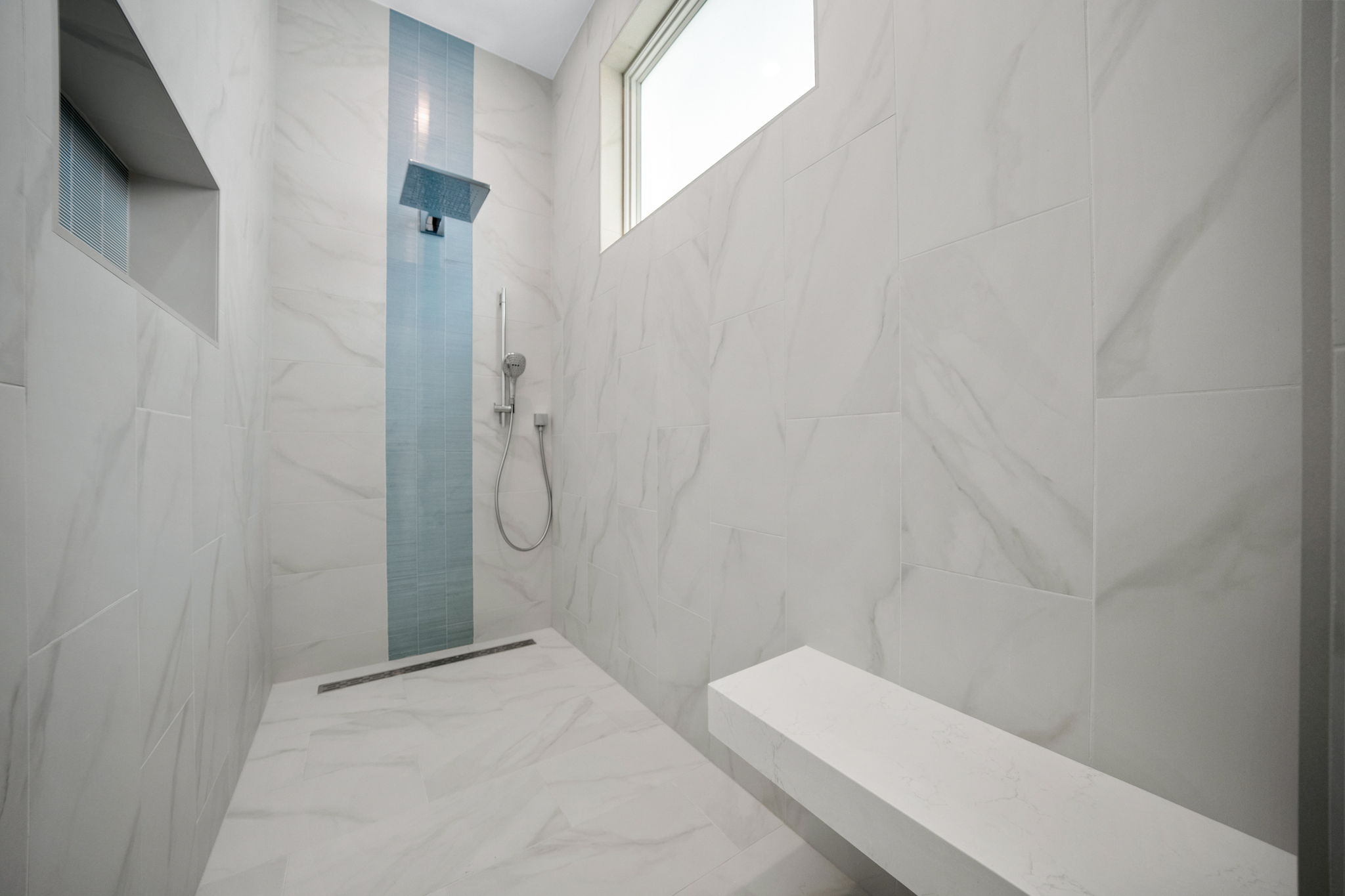 Oversized walk-in shower with large sitting bench