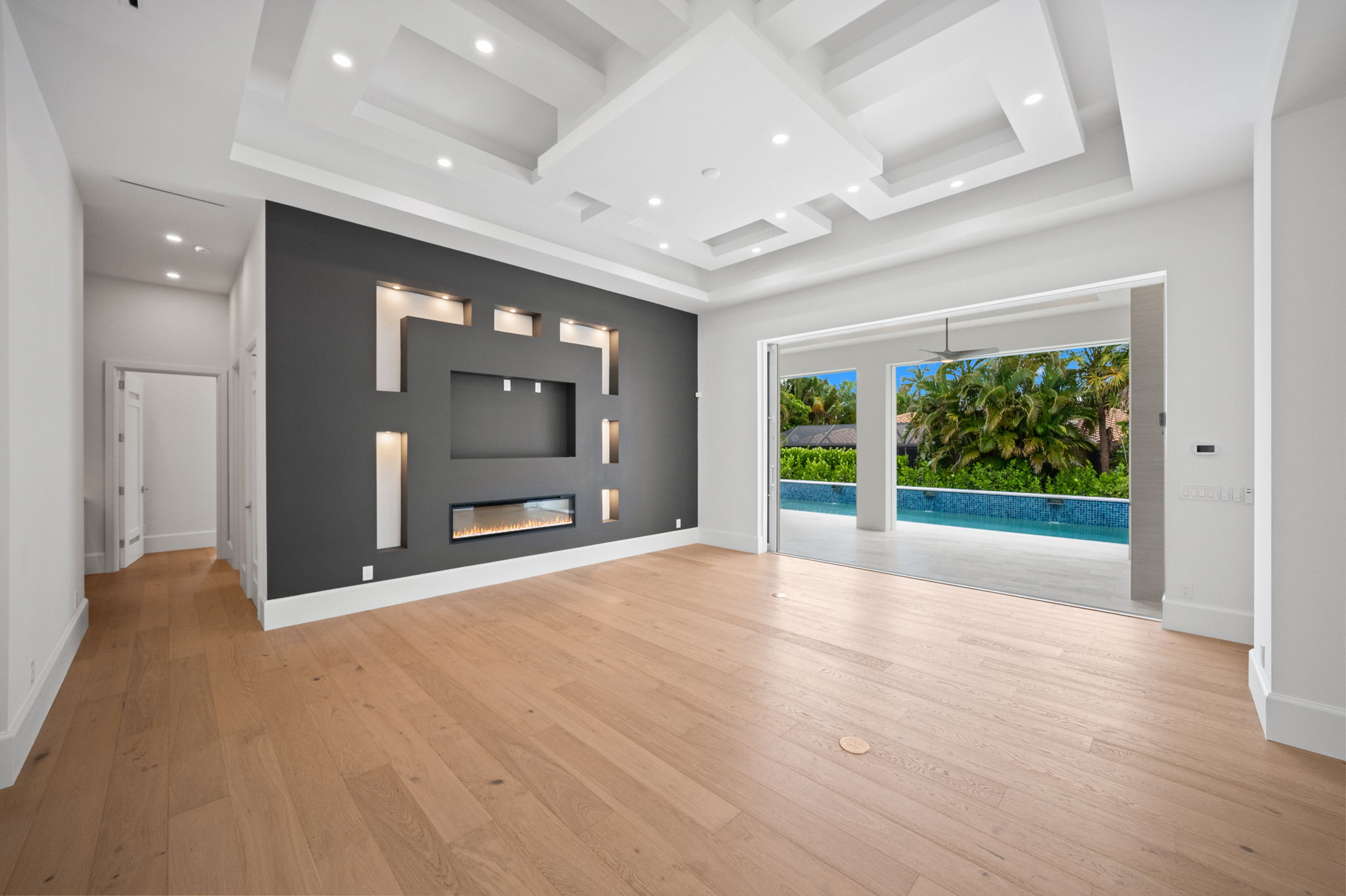 Living room with focal wall detail with decorative lighting and fireplace