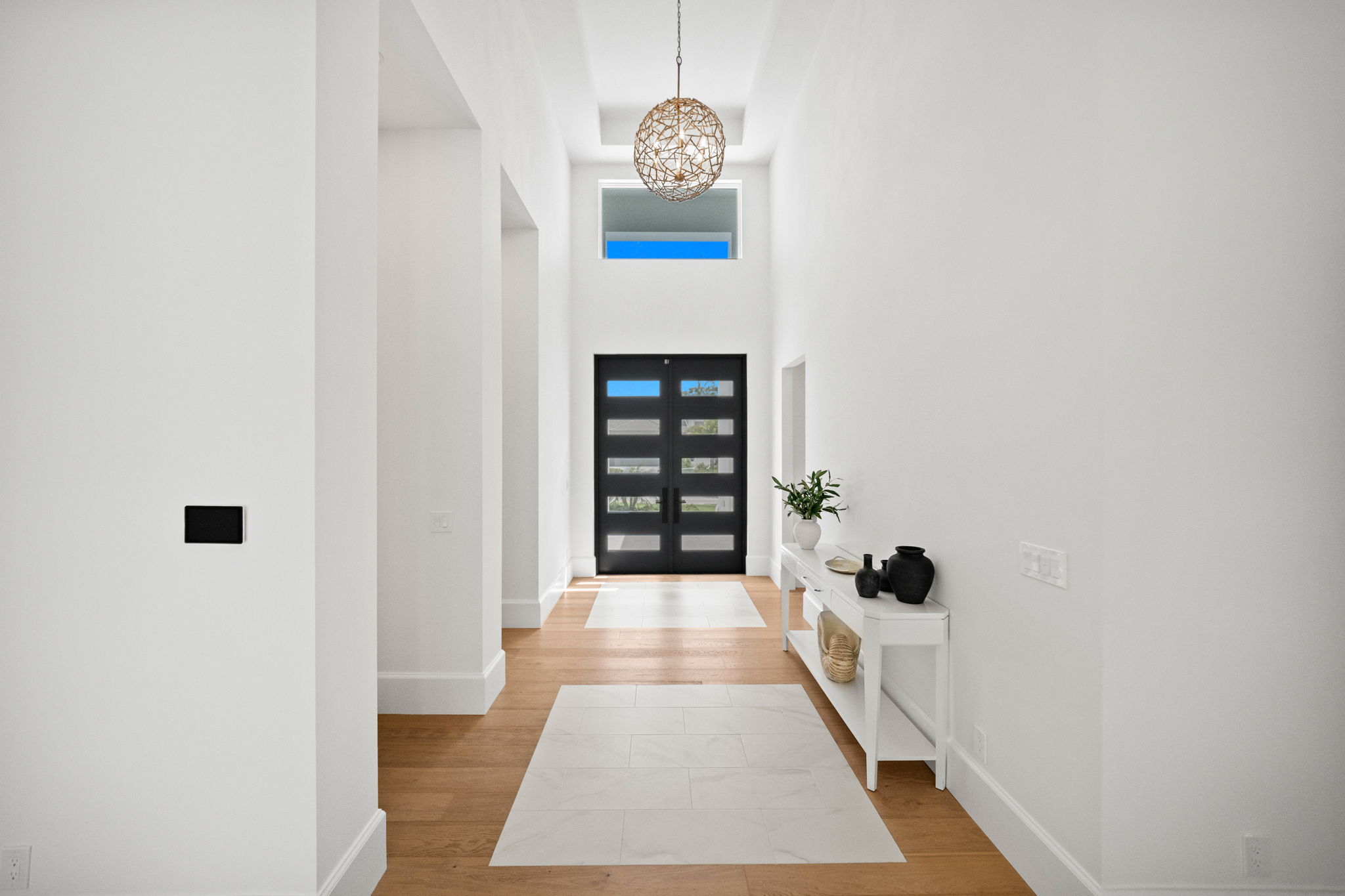 Entryway featuring decorative tile inlays