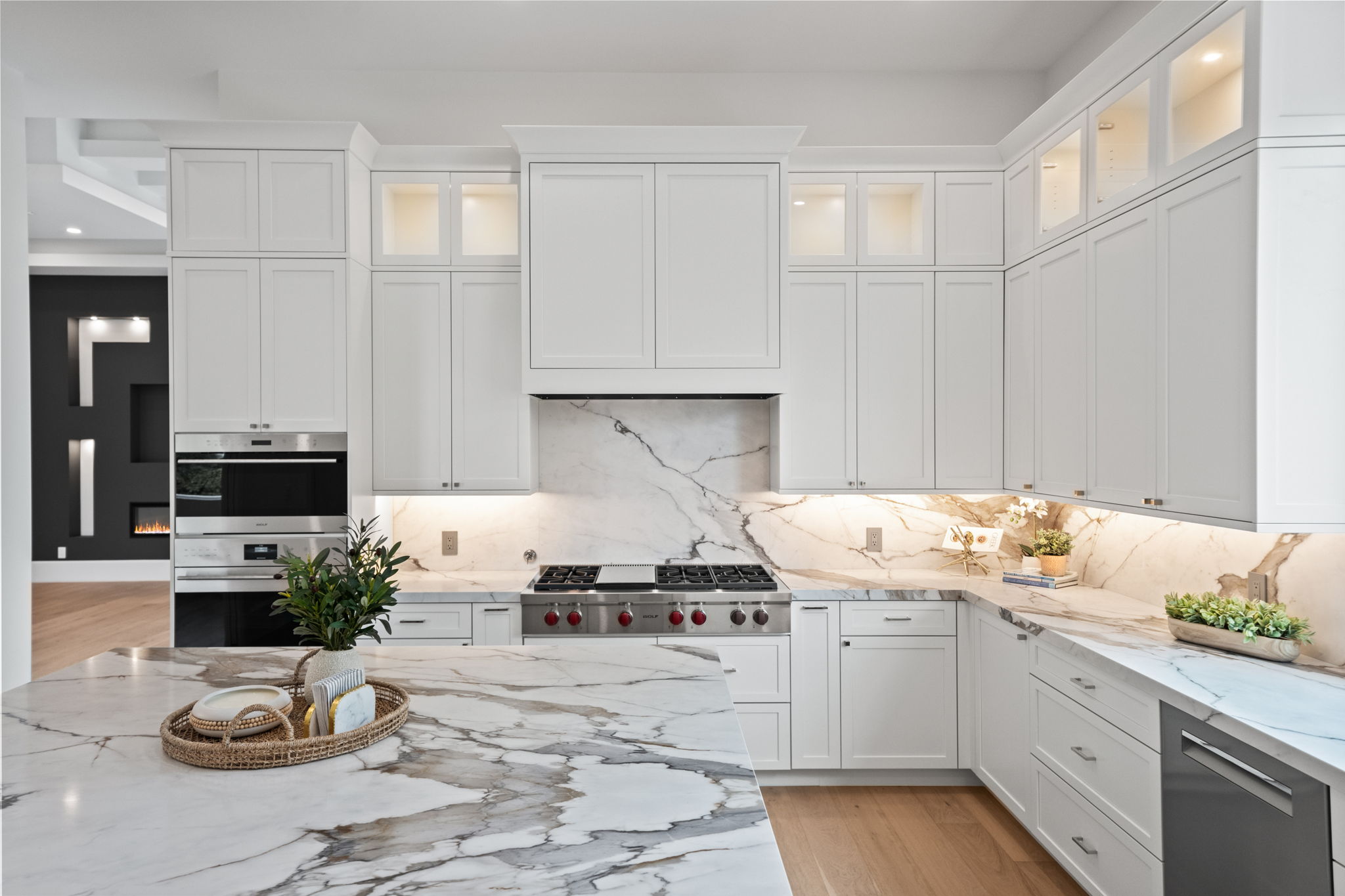 Kitchen featuring oversized island with mitered quartz countertops