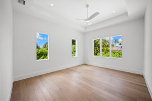 Light-filled primary suite with expansive windows that bring in abundant natural light
