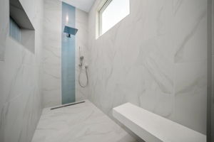 Oversized walk-in shower with large sitting bench