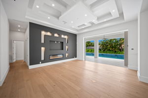 Living room with focal wall detail with decorative lighting and fireplace