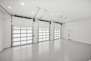 Oversized 3 car stall garage with 10' doors, epoxy floors, room for 3 car lift