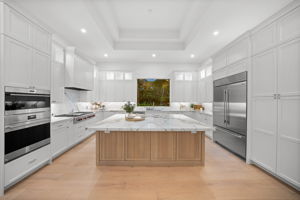 Kitchen with extended upper decorative cabinets