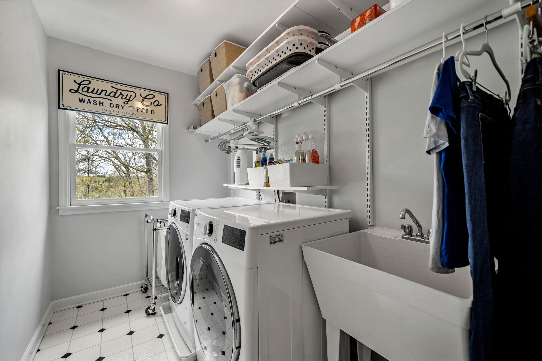 Second floor laundry with ample storage and coat closet - flanks the Primary bedroom.